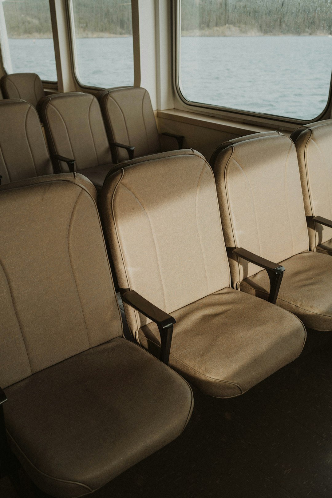 Empty seats on a boat with a scenic view.