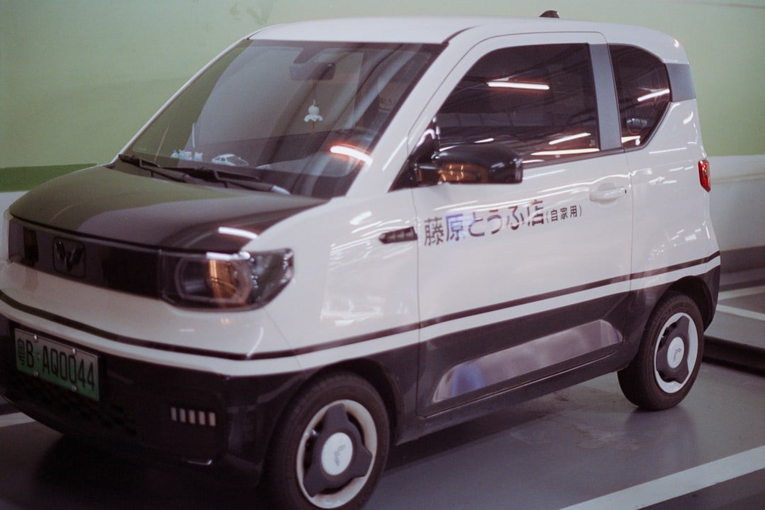 Small white and black electric car parked indoors.