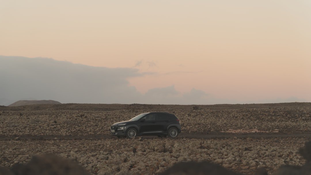 black suv on brown field during daytime