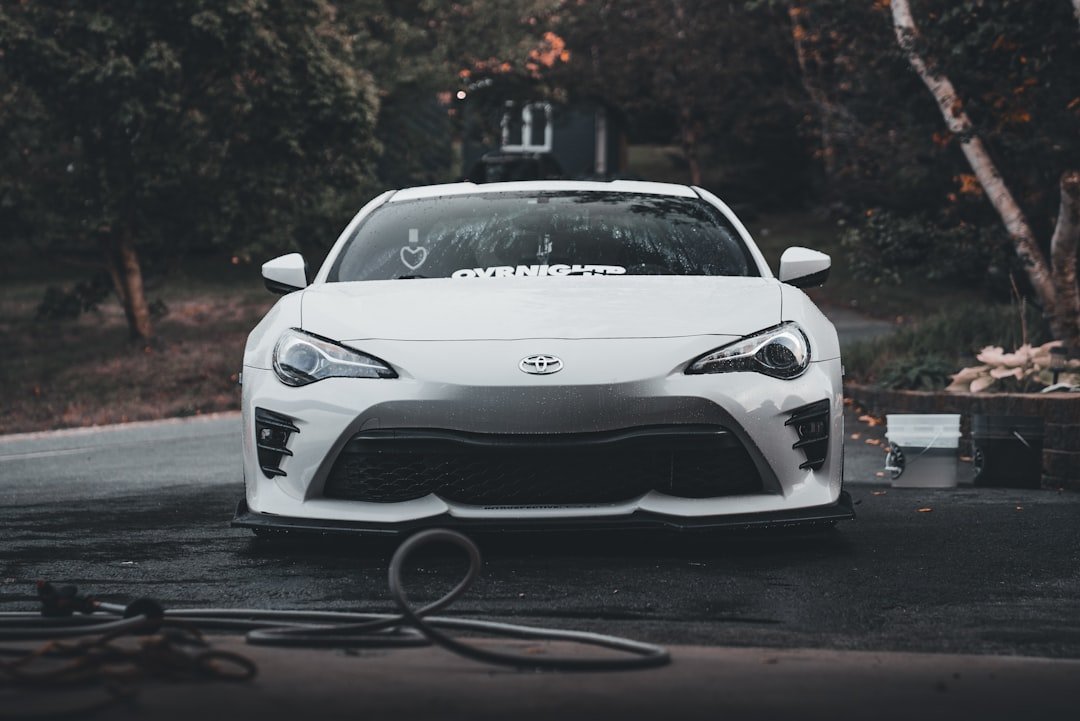 A white sports car parked in a parking lot