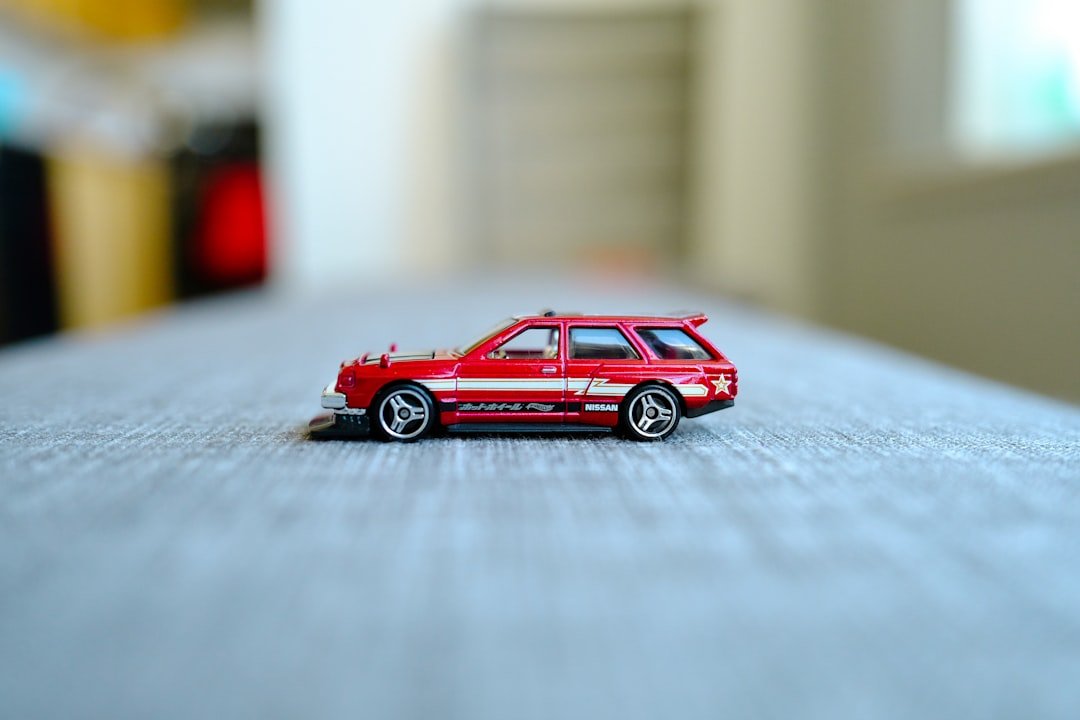 a red toy car sitting on top of a table