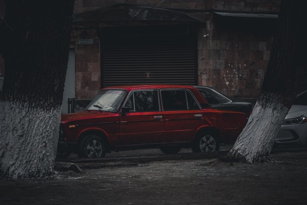 a red car parked in front of a building