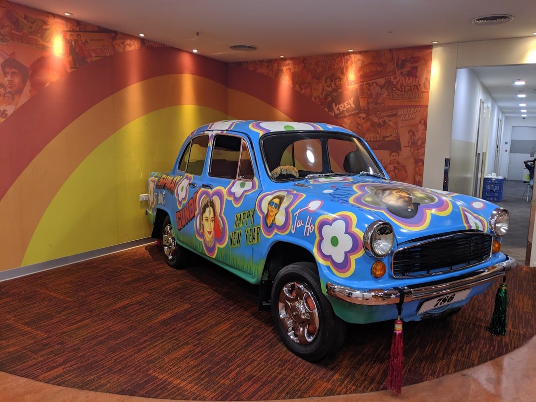 A colorful car is parked inside of a building