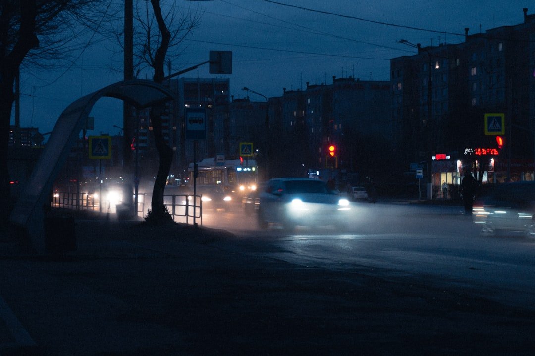 a car driving down a street at night