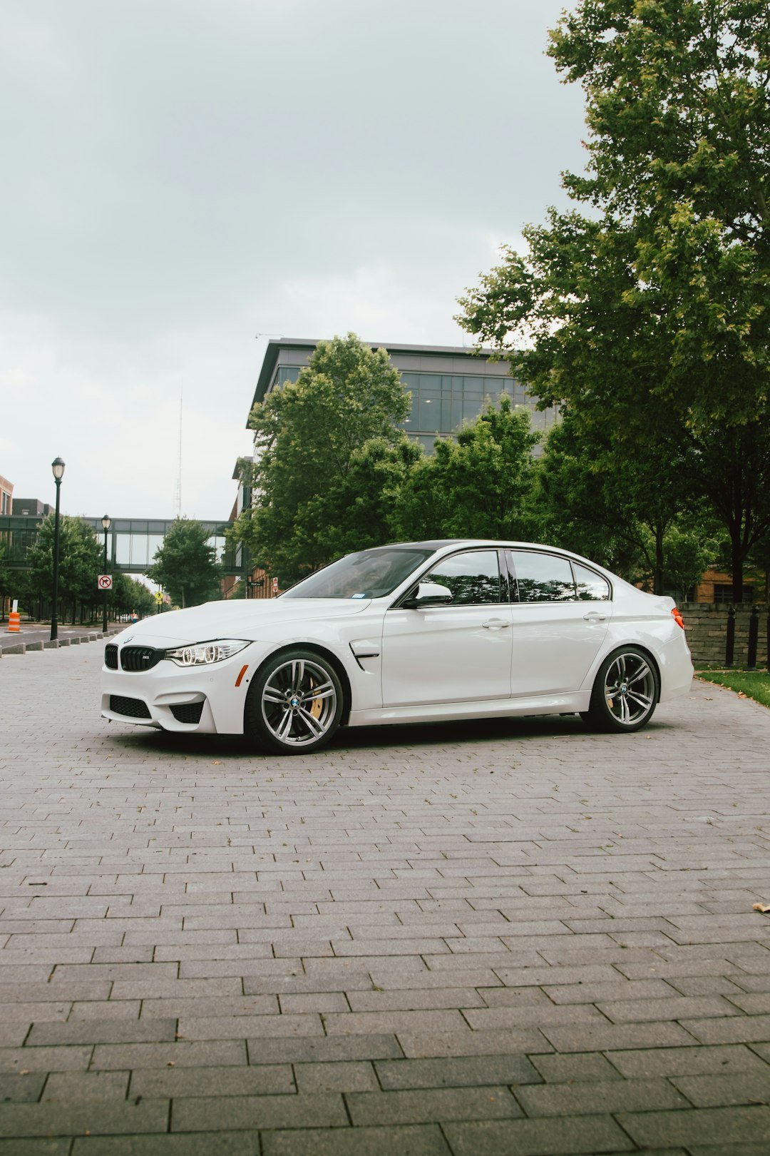 A white BMW sedan is parked outdoors.