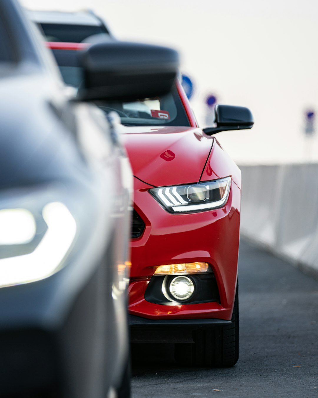 a line of cars parked on a road next to each other