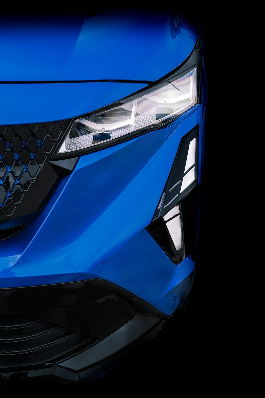 A close up of the front of a blue car