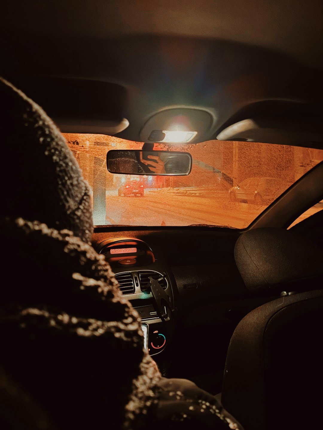 The interior of a car with a person sitting in the passenger seat