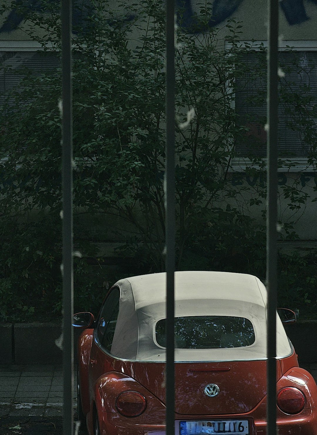 a red and white car parked in front of a building