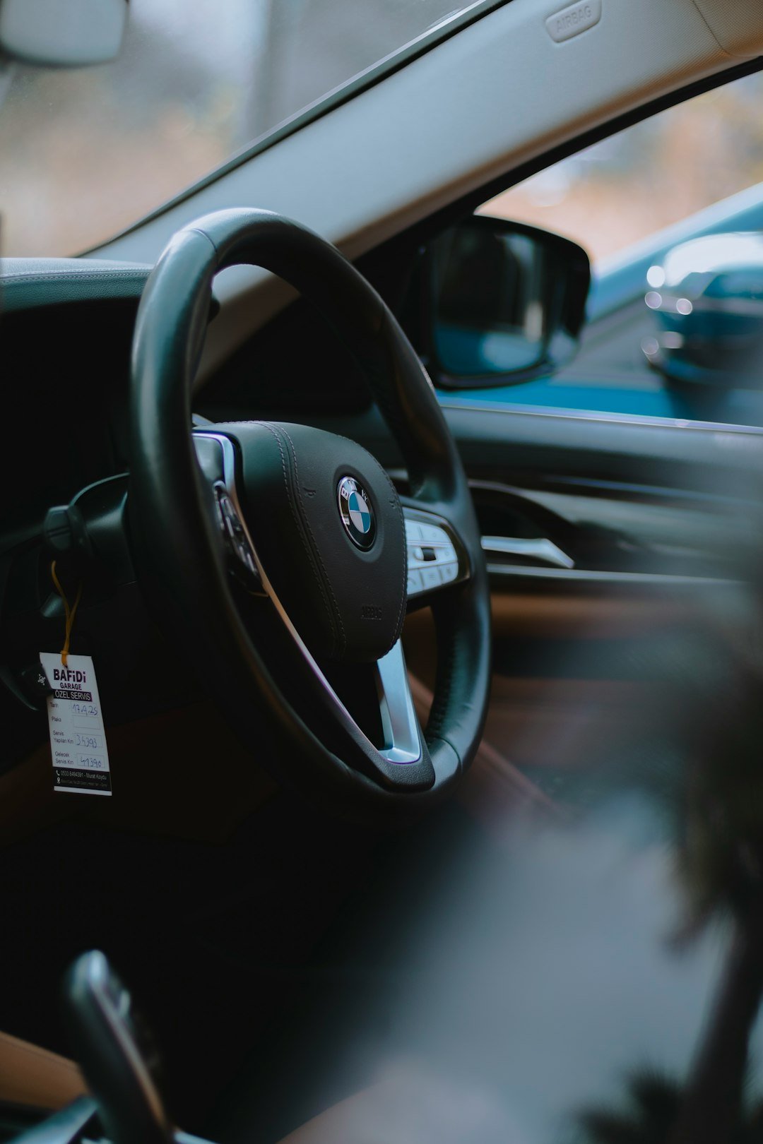 Interior view of a BMW steering wheel and dashboard