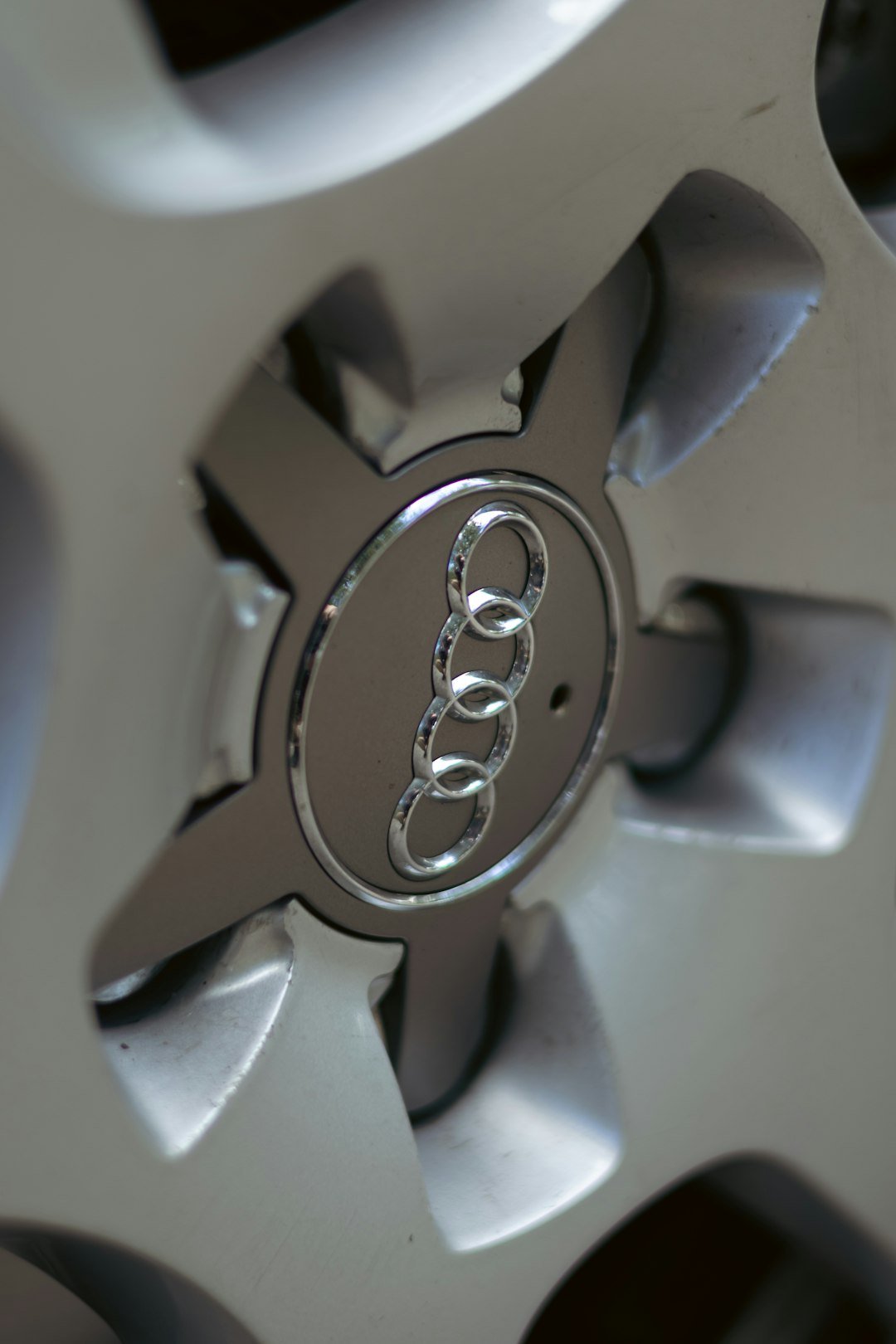 An audi logo is seen on a car wheel.