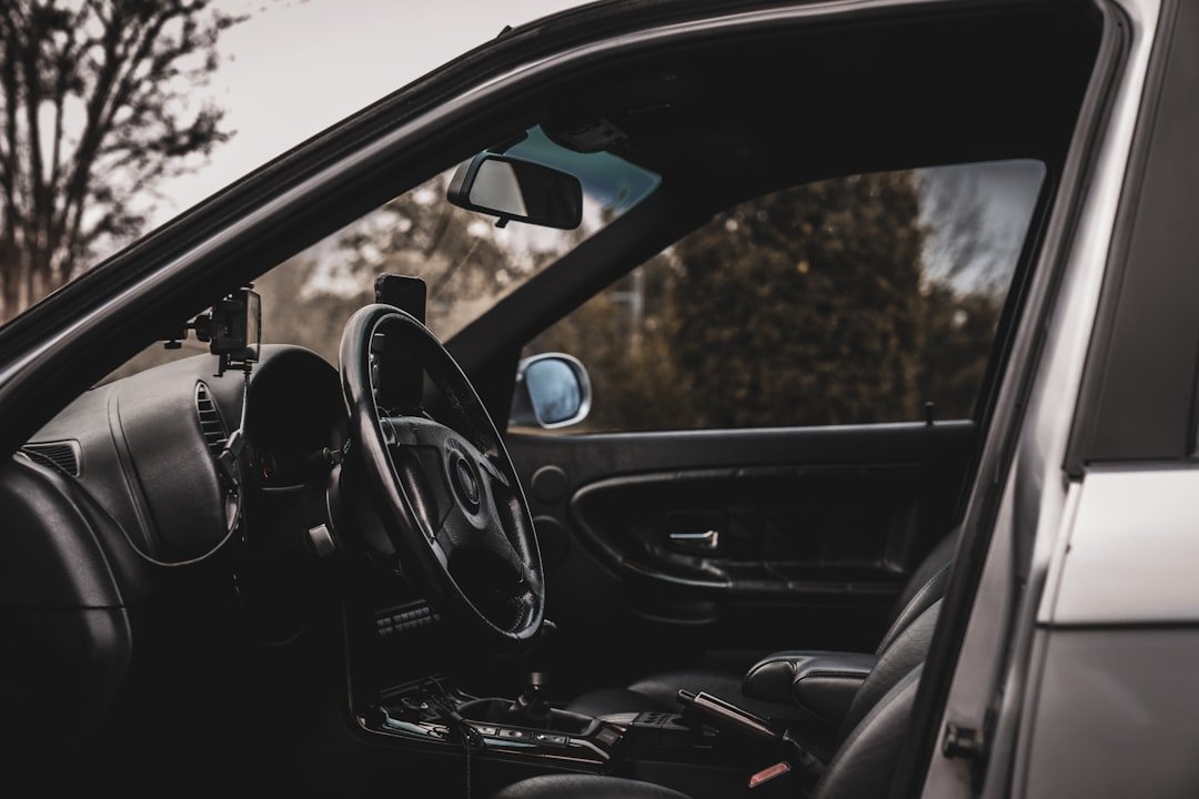 the interior of a car with a steering wheel and dashboard