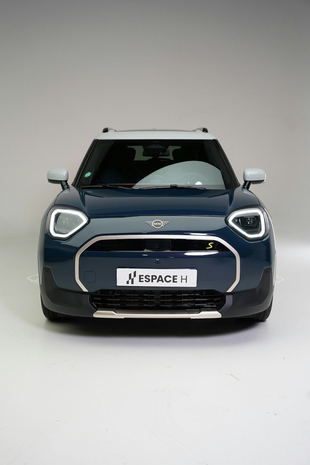 Front view of a dark blue mini cooper countryman.