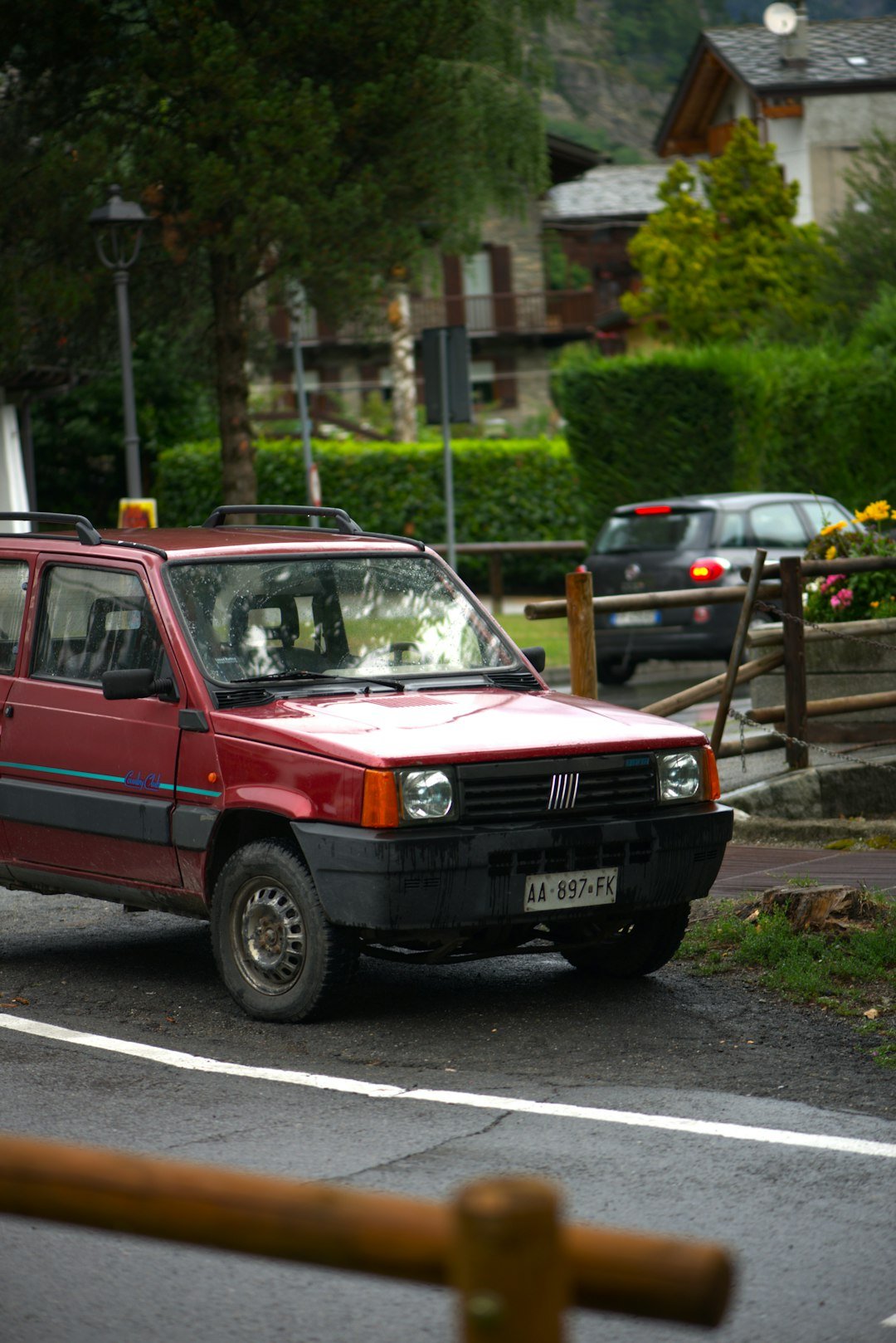 A red fiat panda parked on a street.