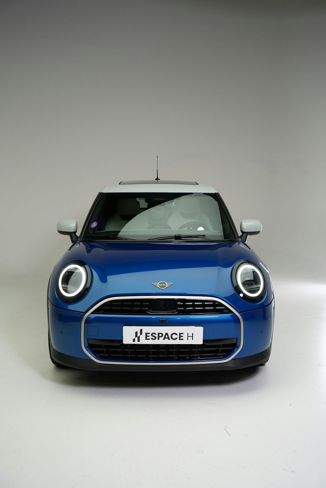 Blue mini cooper parked in a studio
