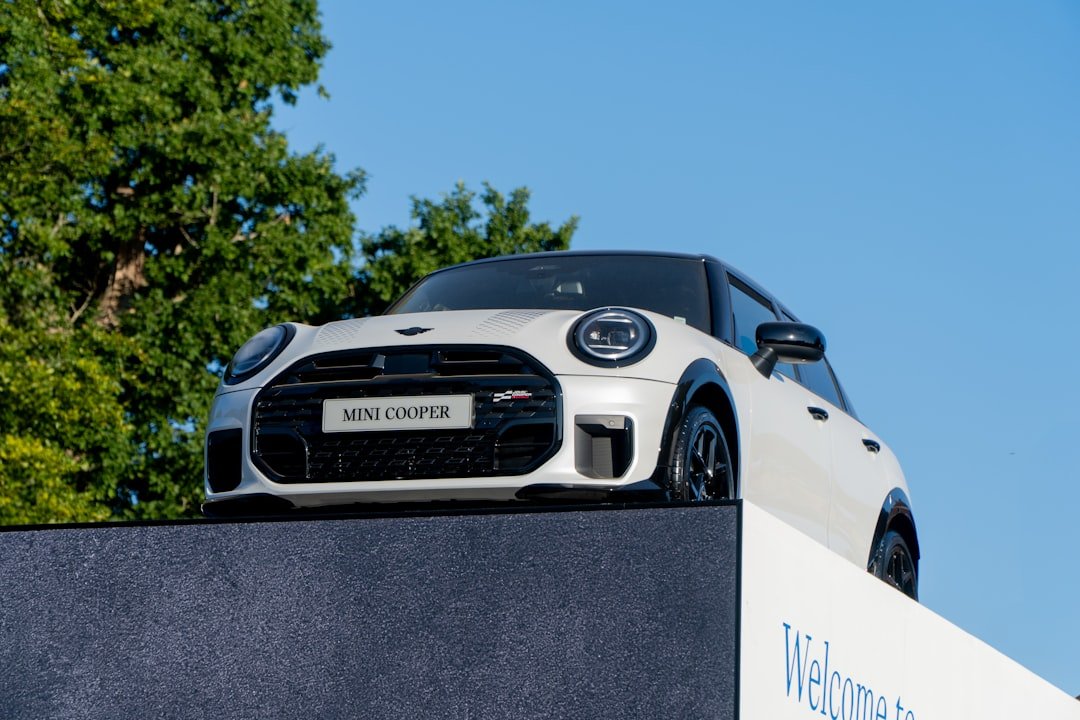 A white mini cooper sits on a platform.