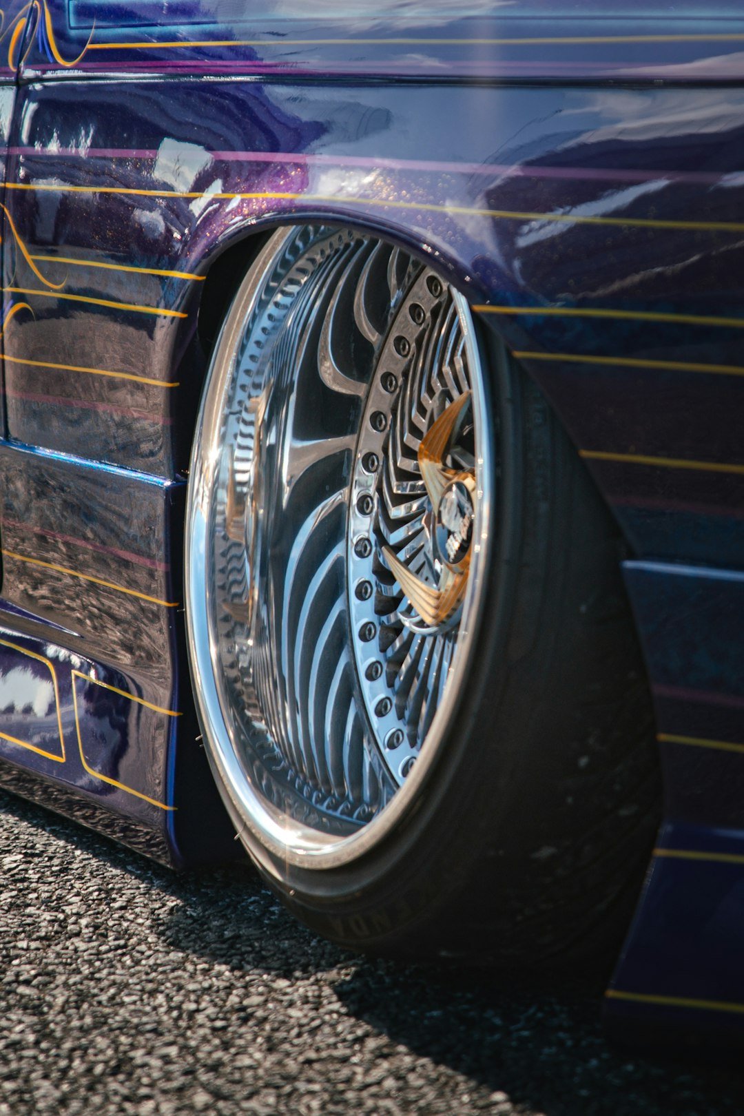 Custom chrome wheel on a slammed purple car