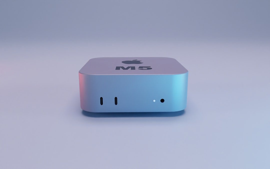 Silver apple mac mini computer on white surface