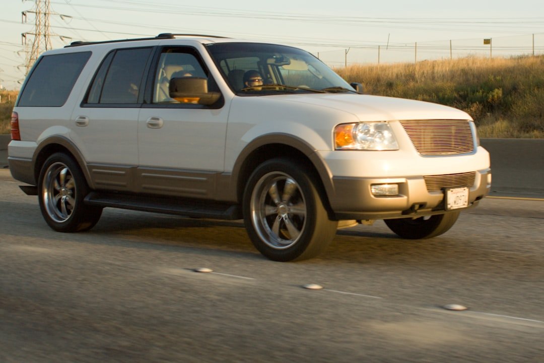 White suv driving on a highway during the day