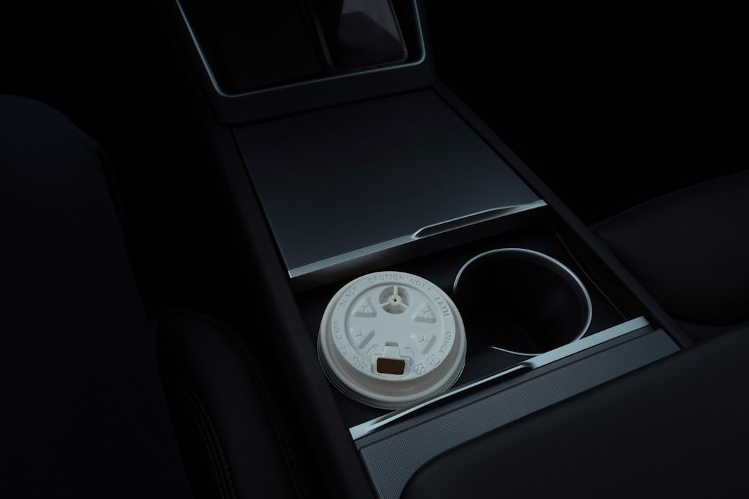 Disposable coffee cup in a car's cup holder.