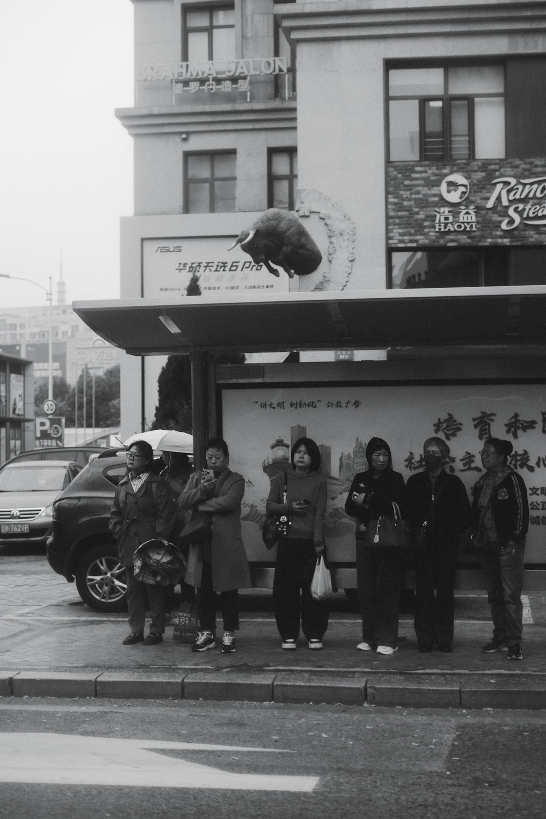 People waiting at a bus stop under an awning.