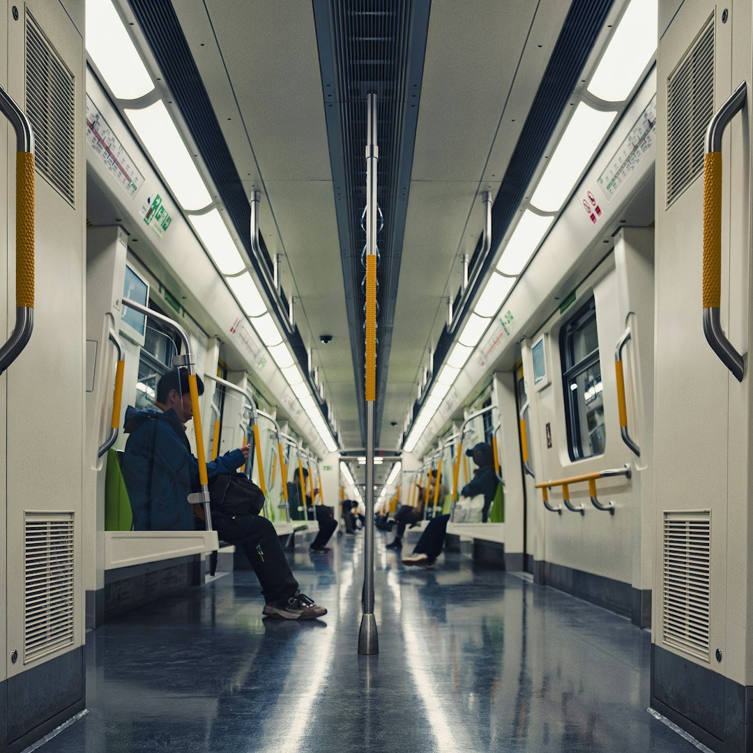 Interior view of a modern subway train with passengers.