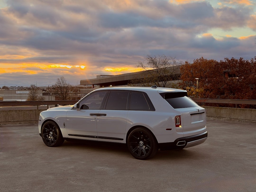 Luxury suv parked on rooftop at sunset