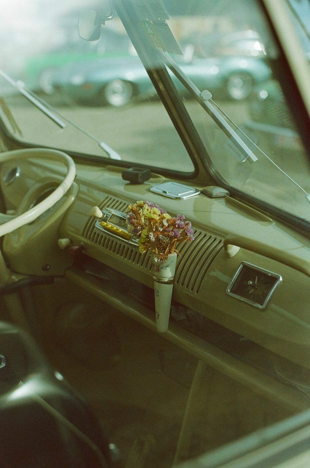 The interior of a car with a steering wheel and dashboard