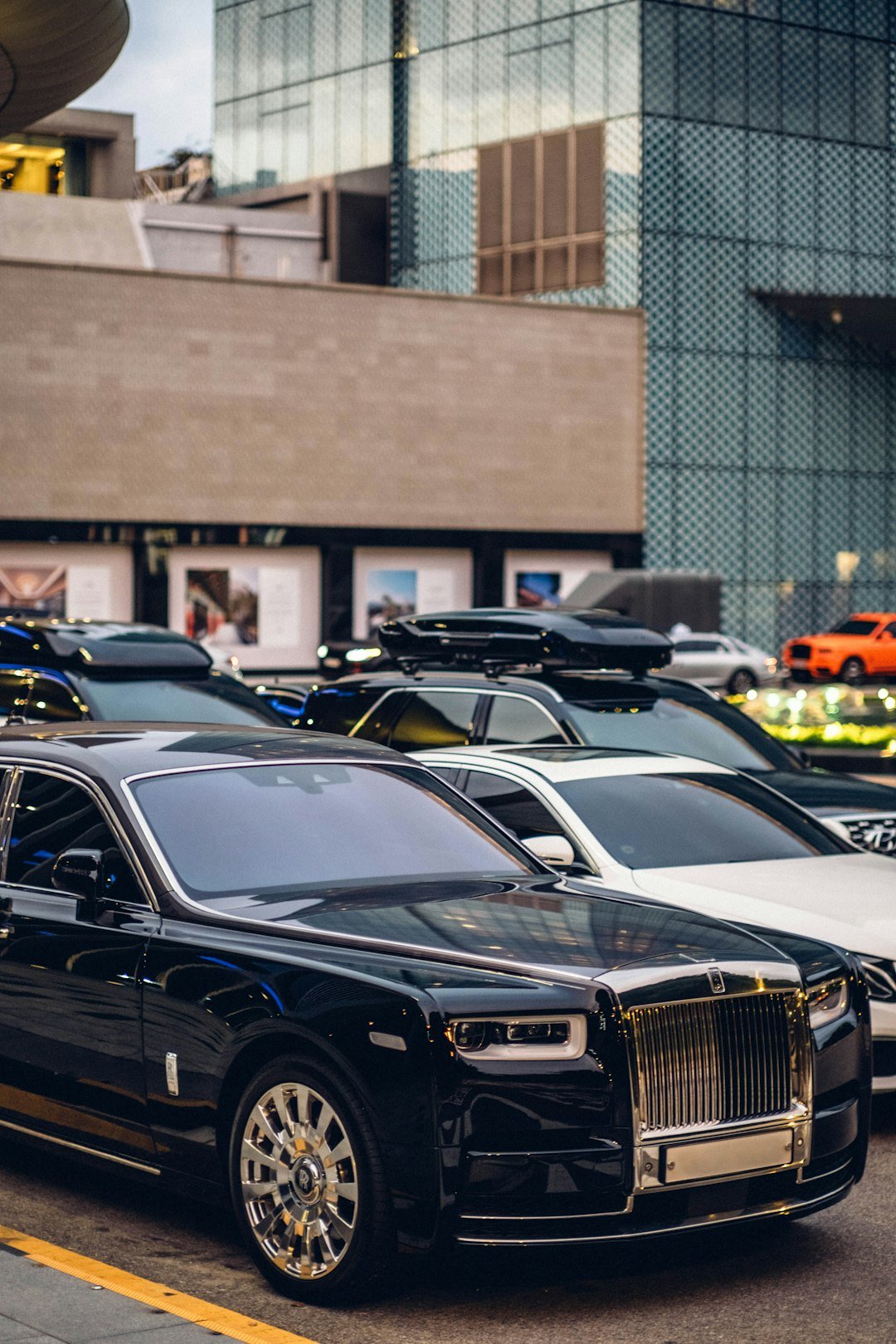 Luxury cars parked on a city street