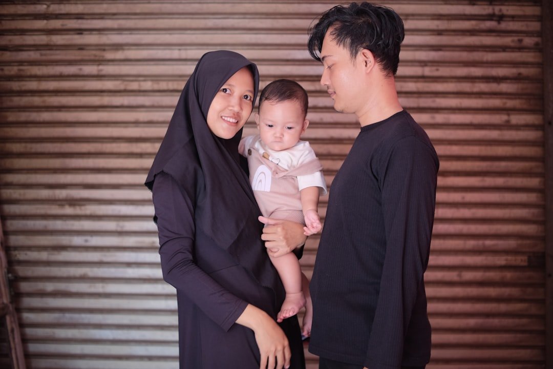 a man and a woman holding a baby