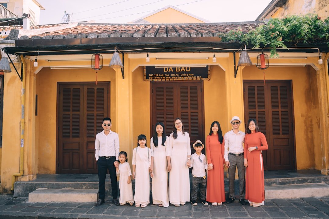 a group of people posing for a photo in front of a building