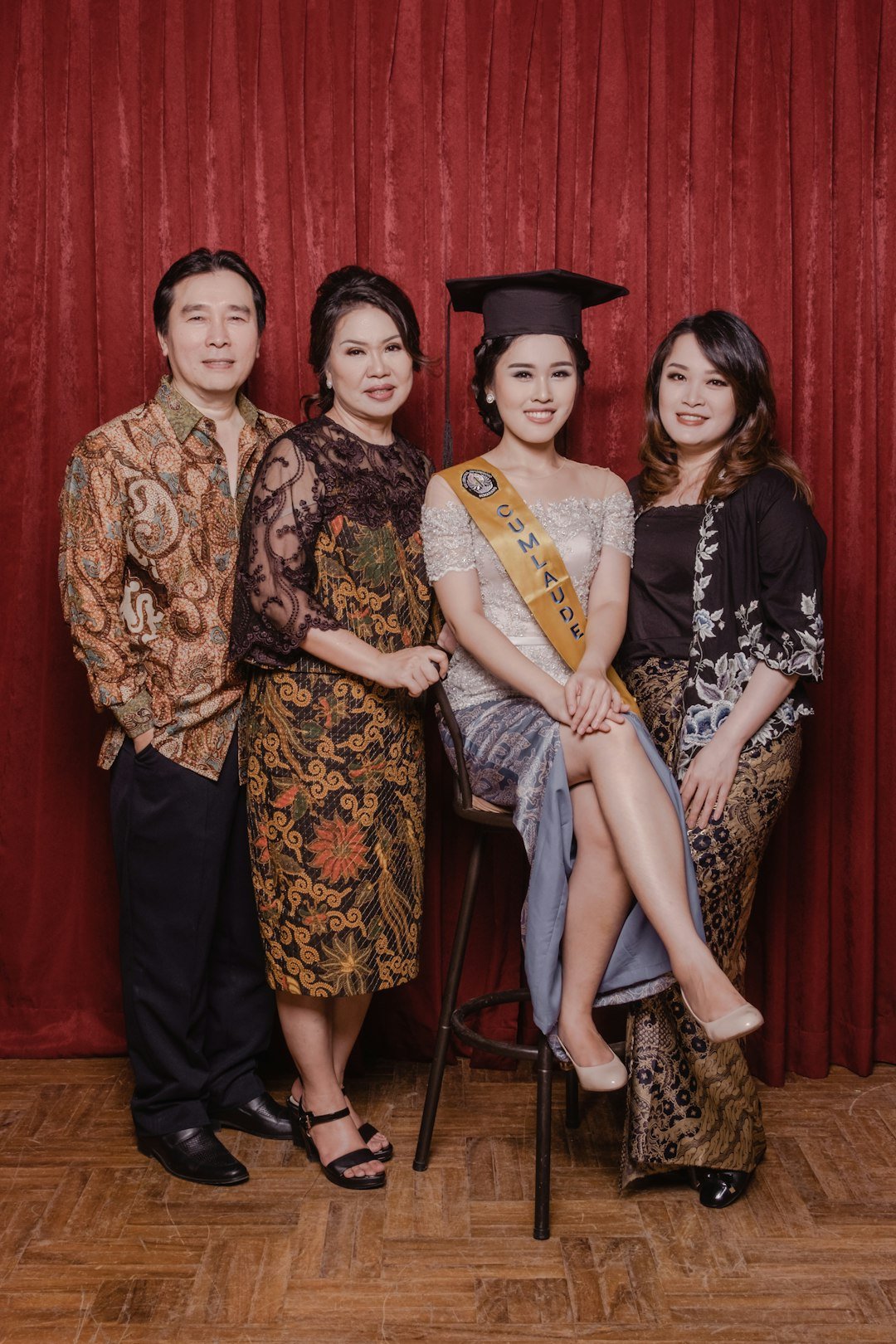 woman in black and brown floral dress beside woman in blue and brown floral dress