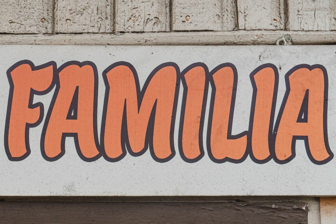 a white sign with orange writing on it