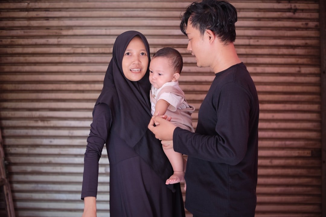 a man and a woman holding a baby