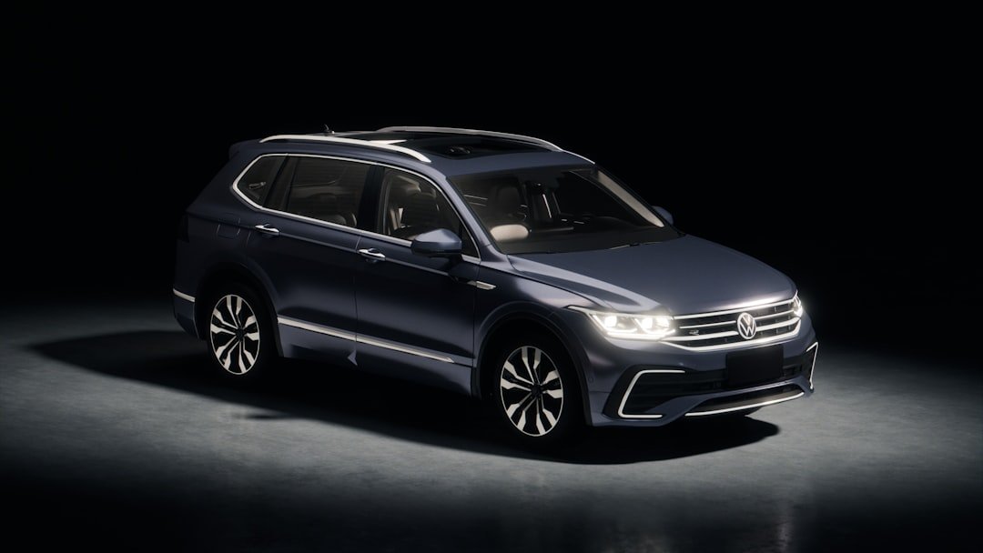 Dark blue suv parked in a studio with spotlights.