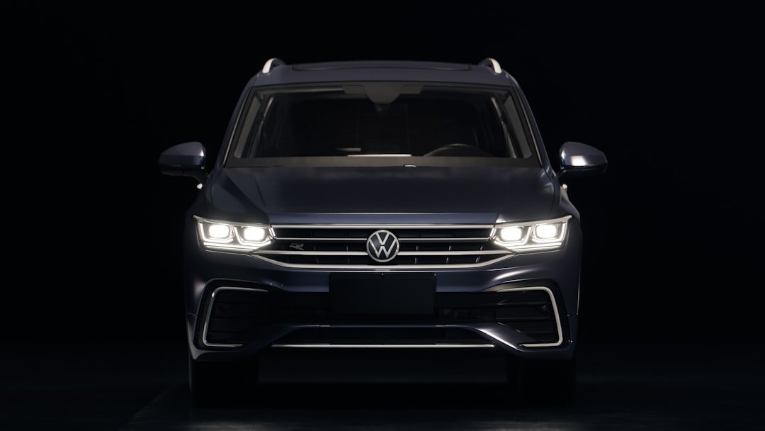 Dark blue volkswagen suv with headlights on