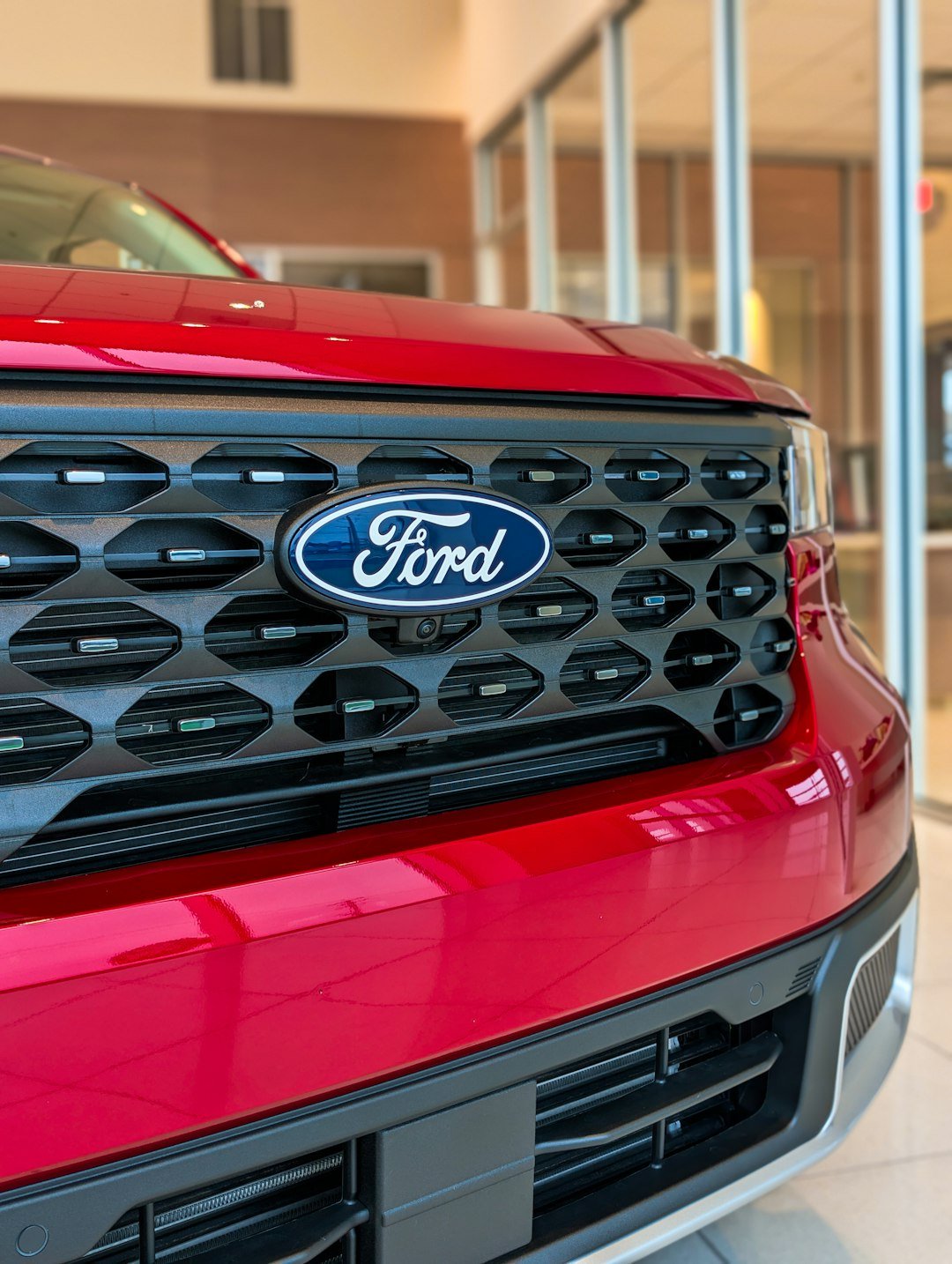 Close-up of a red ford car grille