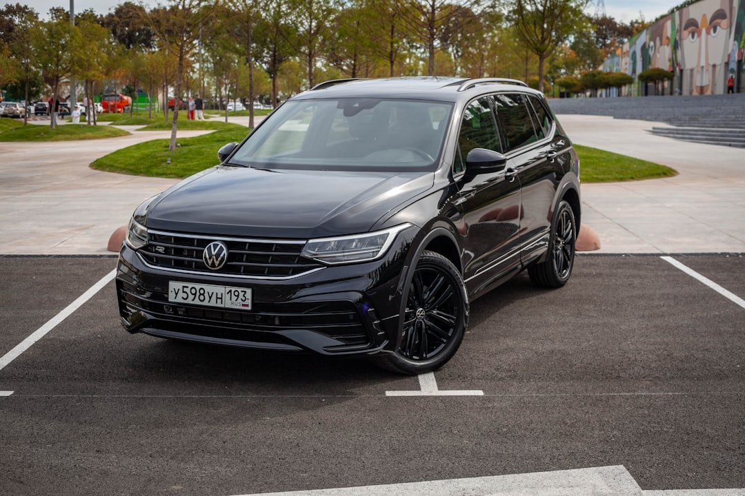 A black volkswagen tiguan parked on asphalt.