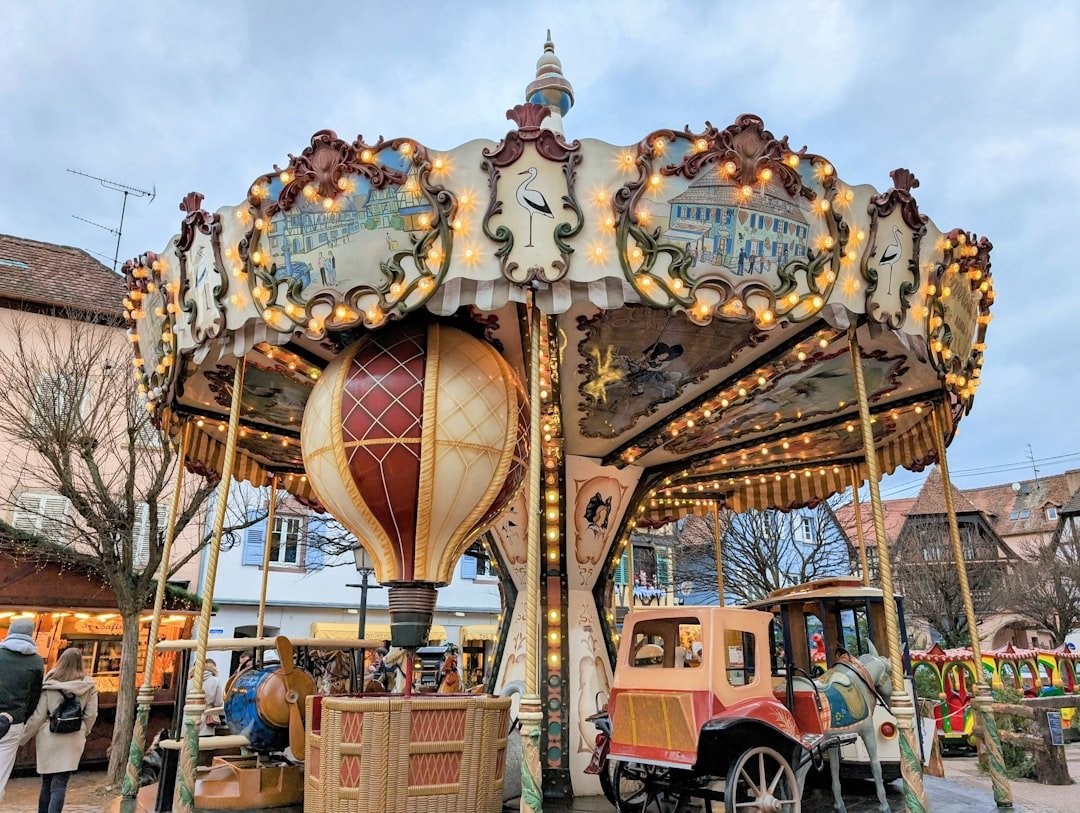 Ornate carousel with hot air balloon and vintage car.
