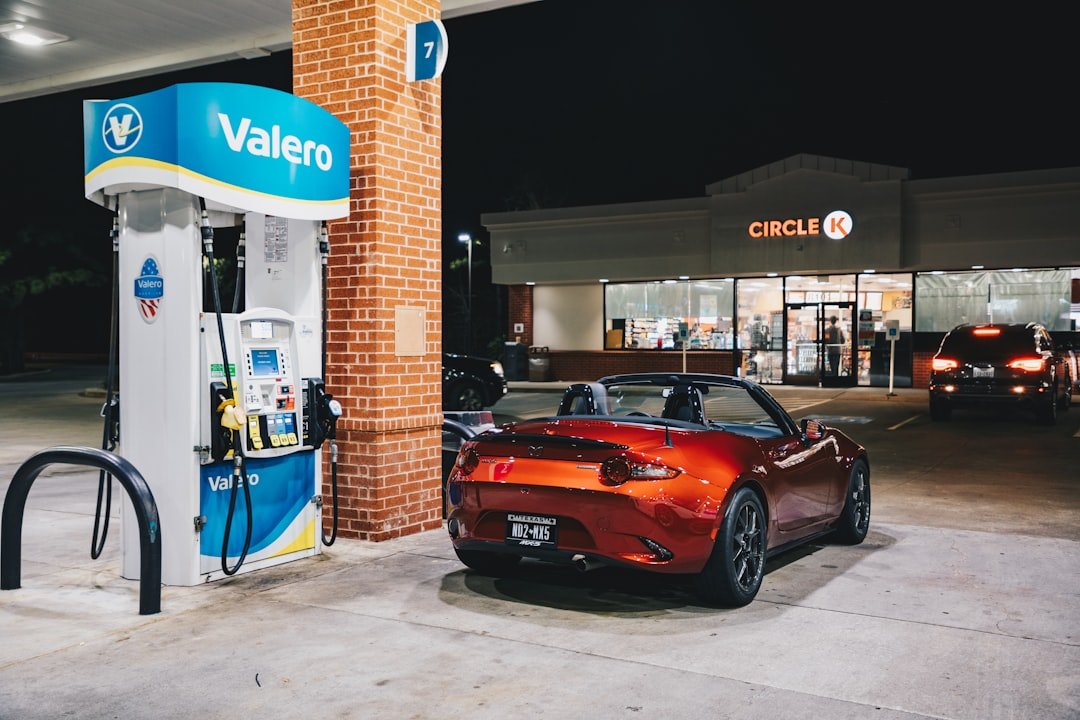 A sports car is parked at a gas station.