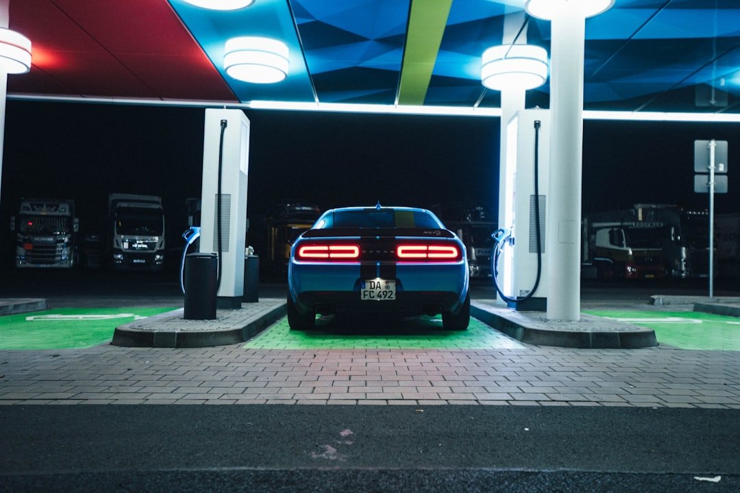 a blue car is parked in a gas station