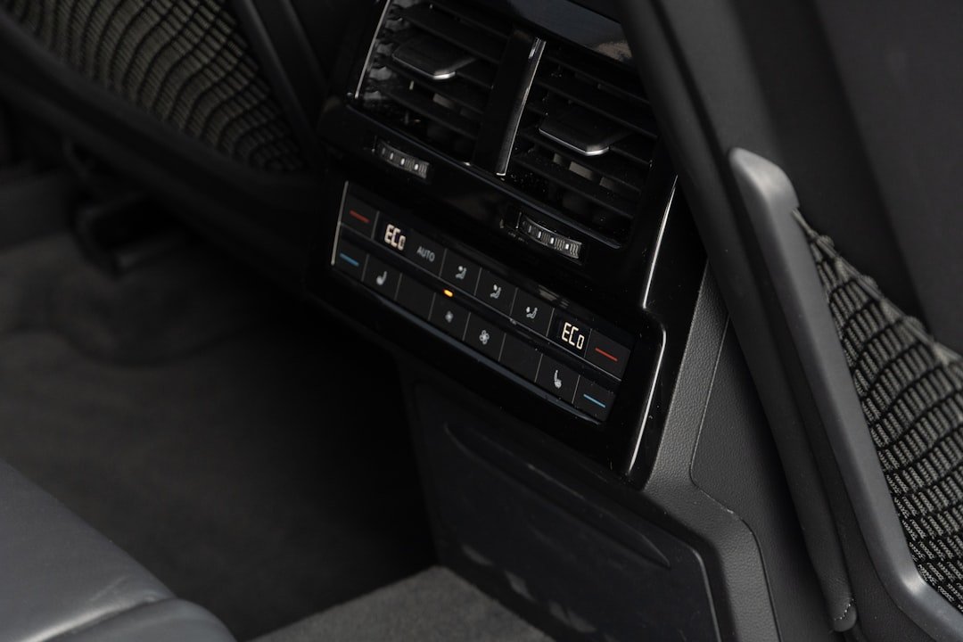 Digital climate control panel in a car's interior.