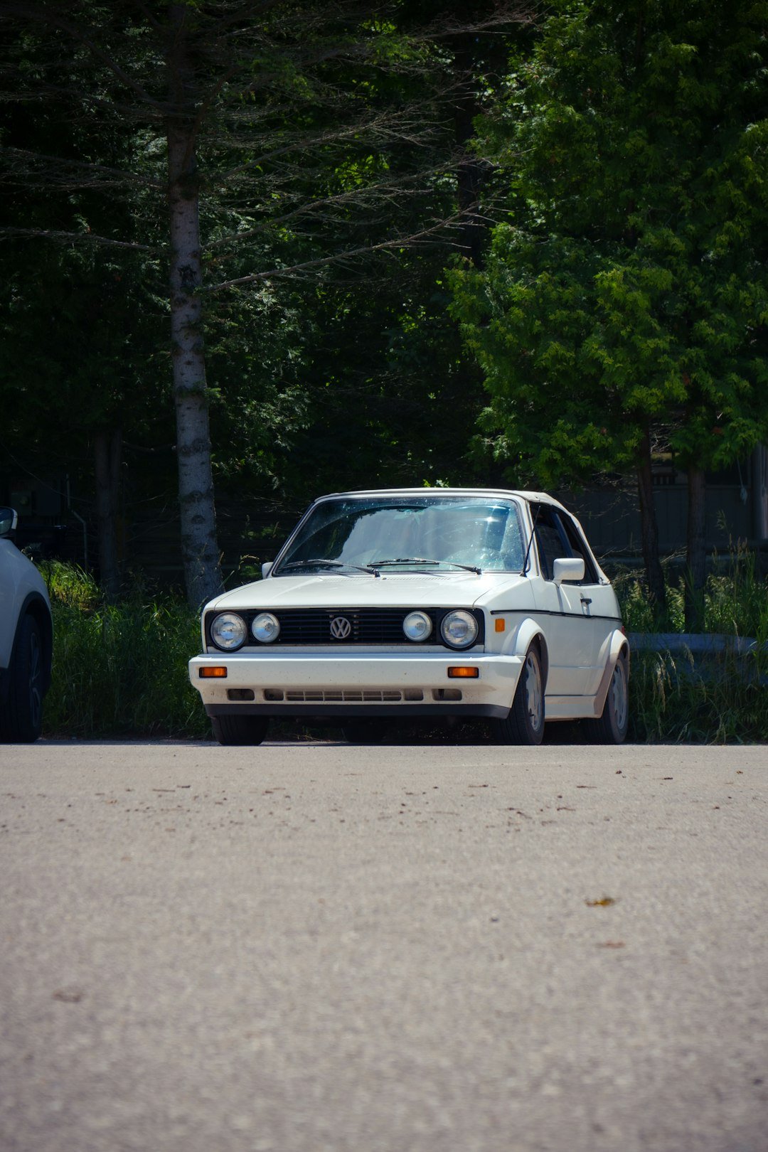 A white car parked on the side of the road