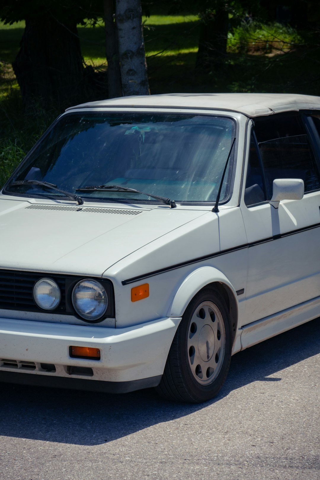 A white car parked on the side of the road