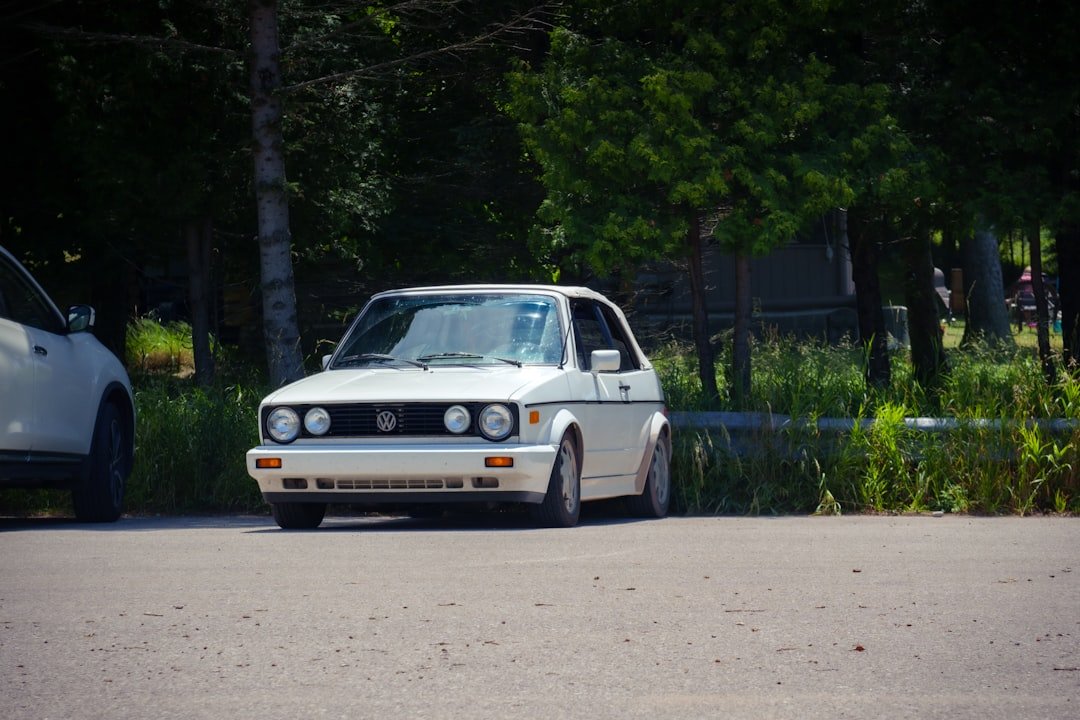 A white car parked on the side of the road