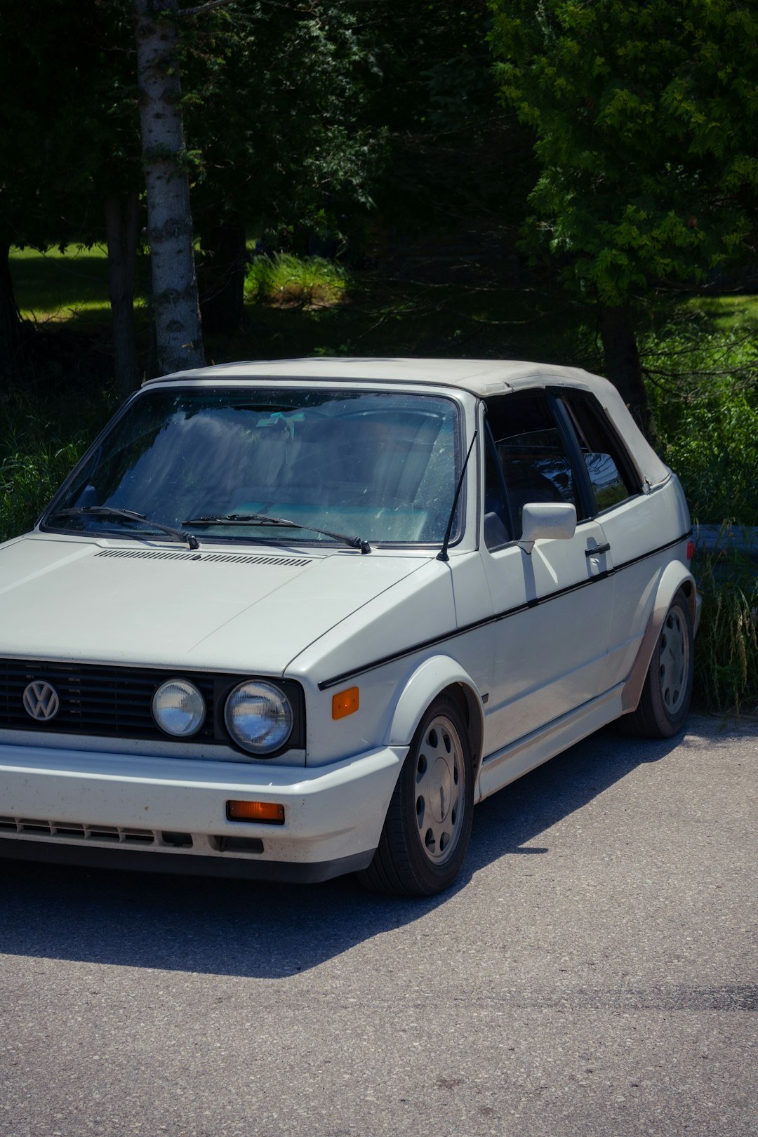A white car parked on the side of the road