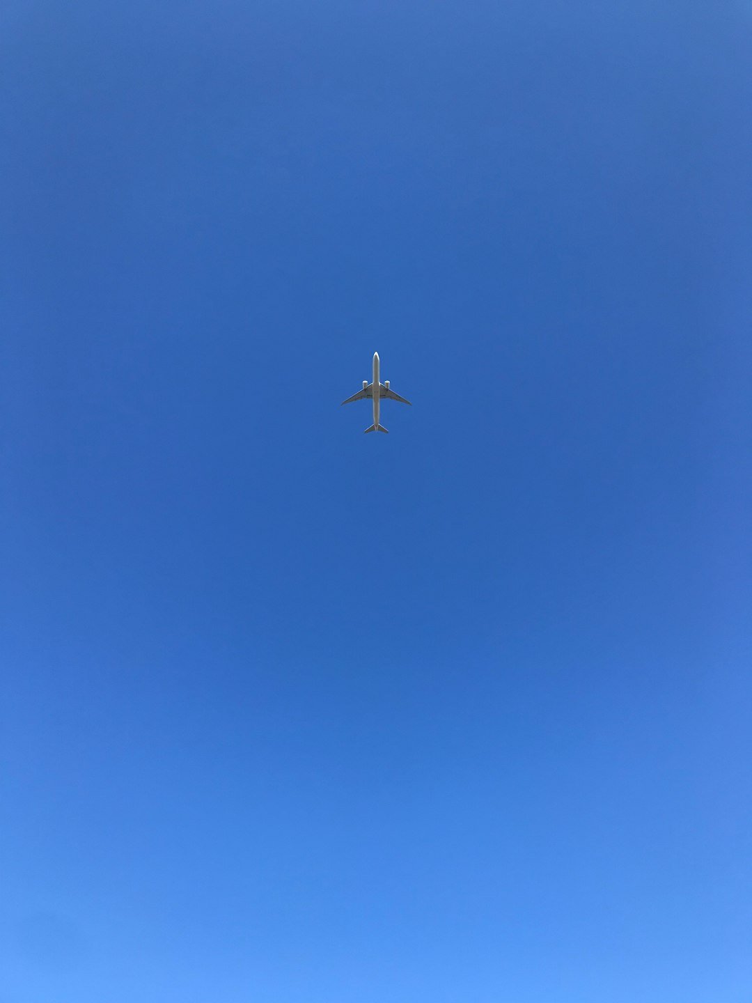 gray airplane flying during daytime