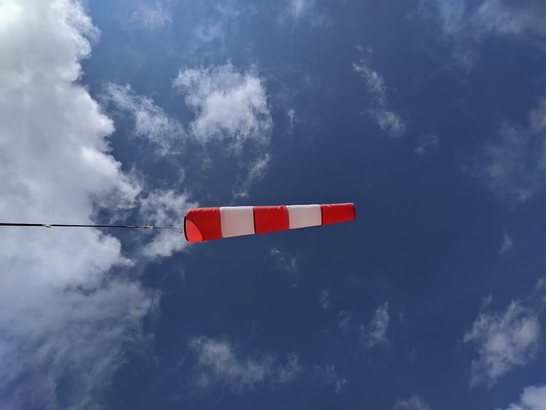 white and red flag under blue sky