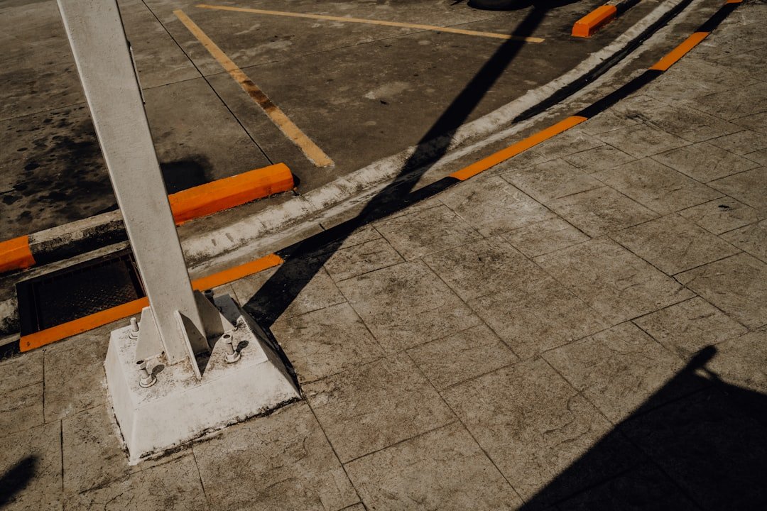 Concrete parking lot details with painted barriers.