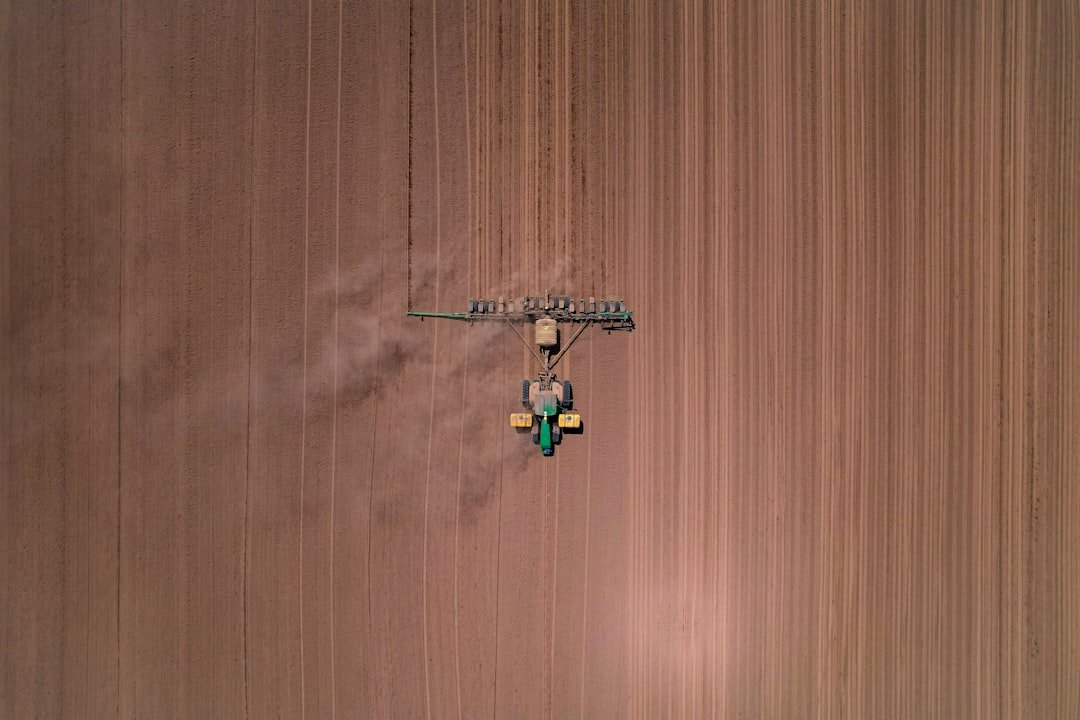 an aerial view of a tractor in a field